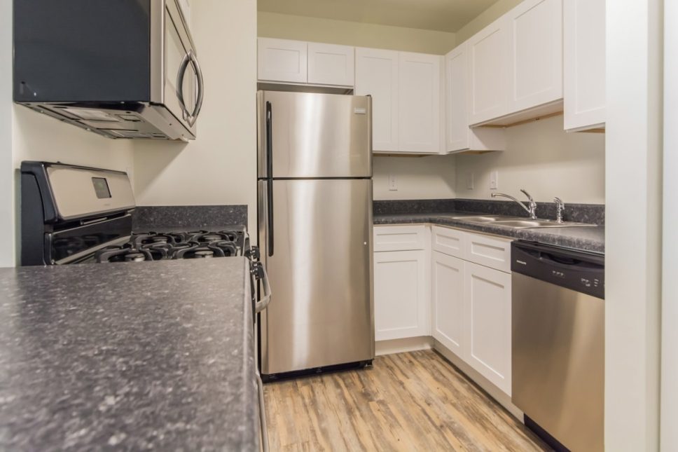 Grove Parkview Apartments in Stone Mountain Apartment with stainless steel appliances and wood floors.