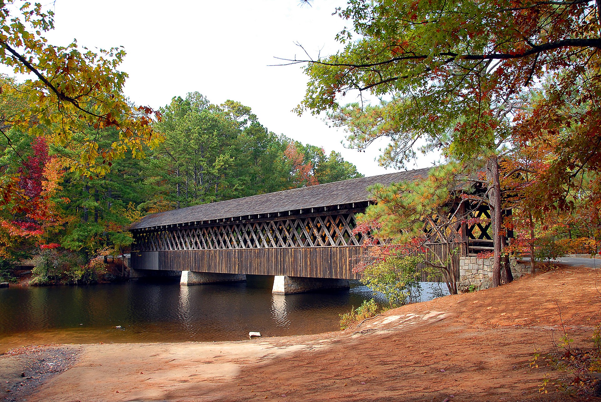A covered bridge over a body of water with a Two Bedroom Apartment.